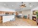Bright and airy living space with wood-look floors, vaulted ceilings, and a fireplace, perfect for entertaining at 16924 W Stevenage St, Surprise, AZ 85374
