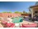 Inviting backyard pool with rock accents and a serene desert landscape, perfect for relaxation and outdoor enjoyment at 16924 W Stevenage St, Surprise, AZ 85374