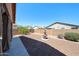 View of the backyard with a desertscape, decorative fountain, and block wall for privacy at 17050 W Manchester Dr, Surprise, AZ 85374