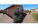 Landscaped backyard featuring desert plants, a fountain, and side of the home at 17050 W Manchester Dr, Surprise, AZ 85374