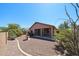 View of the landscaped backyard with a fountain, patio, and desert plants at 17050 W Manchester Dr, Surprise, AZ 85374