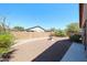 A peaceful backyard featuring desert landscaping and a charming tiered fountain at 17050 W Manchester Dr, Surprise, AZ 85374