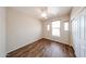 This bedroom features a ceiling fan, wood-look floors, windows, and a closet at 17050 W Manchester Dr, Surprise, AZ 85374