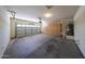 View of the garage with built-in storage cabinets and plenty of open space at 17050 W Manchester Dr, Surprise, AZ 85374