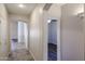Hallway featuring arched doorways, tile flooring and neutral paint at 17050 W Manchester Dr, Surprise, AZ 85374