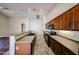 Well-equipped kitchen with wood cabinets, countertop, and black appliances at 17050 W Manchester Dr, Surprise, AZ 85374