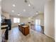 Open-concept kitchen overlooking the dining area, with laminate wood flooring at 17050 W Manchester Dr, Surprise, AZ 85374