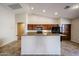 Bright kitchen with island, raised ceiling and ample cabinet space at 17050 W Manchester Dr, Surprise, AZ 85374