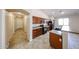 Open kitchen with wood cabinetry, black appliances and a breakfast bar at 17050 W Manchester Dr, Surprise, AZ 85374
