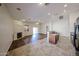 Open concept living room features a fireplace, sliding glass doors, and a view to the kitchen at 17050 W Manchester Dr, Surprise, AZ 85374