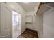 Walk-in closet with custom shelving and a view into the bathroom at 17050 W Manchester Dr, Surprise, AZ 85374