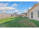 View of backyard featuring green lawn, covered patio, storage shed, and block fence at 18629 N 10Th Ave, Phoenix, AZ 85027