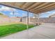View of a backyard featuring a covered patio, green lawn, storage shed, and block fence for privacy at 18629 N 10Th Ave, Phoenix, AZ 85027