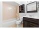 Cozy bathroom with dark wood vanity, tub, and warm lighting at 18629 N 10Th Ave, Phoenix, AZ 85027