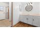 Bright bathroom with white vanity, round mirror, and shower with glass door at 18629 N 10Th Ave, Phoenix, AZ 85027