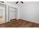 Bright bedroom features wood floors, ceiling fan, and closet with bi-fold doors at 18629 N 10Th Ave, Phoenix, AZ 85027
