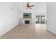 A spacious living room with tile floors, a fireplace, and sliding glass doors to backyard at 18629 N 10Th Ave, Phoenix, AZ 85027