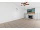 An empty living room with tile floors, a fireplace, and white walls at 18629 N 10Th Ave, Phoenix, AZ 85027