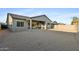 Backyard with covered patio, gravel, and block fence; perfect for outdoor entertaining and low-maintenance landscaping at 19231 W Missouri Ave, Litchfield Park, AZ 85340