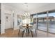 Bright dining area featuring a stylish table, modern light fixture, and sliding glass doors at 19231 W Missouri Ave, Litchfield Park, AZ 85340