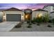 Attractive single-story home featuring desert landscaping, with a grey two-car garage at 19231 W Missouri Ave, Litchfield Park, AZ 85340