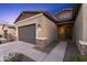 Inviting single-story home with a two-car garage, desert landscaping, and a cozy entrance at 19231 W Missouri Ave, Litchfield Park, AZ 85340