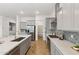 Modern kitchen with a large island, stainless steel appliances, herringbone floors, and ample counter space at 19231 W Missouri Ave, Litchfield Park, AZ 85340