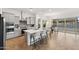 Bright kitchen with island seating open to the dining area, featuring modern appliances and herringbone flooring at 19231 W Missouri Ave, Litchfield Park, AZ 85340