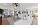 Spacious living room featuring modern décor, herringbone floors, and a view of the kitchen at 19231 W Missouri Ave, Litchfield Park, AZ 85340
