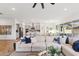 Bright, open-concept living room flows to the kitchen, featuring a large sectional and stylish decor at 19231 W Missouri Ave, Litchfield Park, AZ 85340