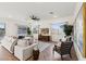 Bright living room with modern furniture, large windows, and stylish herringbone wood floors at 19231 W Missouri Ave, Litchfield Park, AZ 85340