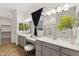 Elegant bathroom featuring dual vanities with a makeup table and stylish accents at 19231 W Missouri Ave, Litchfield Park, AZ 85340