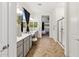 Spacious bathroom with dual sinks, framed mirrors, and glass-enclosed shower at 19231 W Missouri Ave, Litchfield Park, AZ 85340