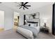 Bright main bedroom featuring plush carpet, stylish décor, and ensuite bathroom access at 19231 W Missouri Ave, Litchfield Park, AZ 85340