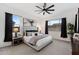 Comfortable main bedroom with plush carpeting, large windows, and black-out curtains at 19231 W Missouri Ave, Litchfield Park, AZ 85340