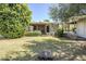 Relax in this landscaped backyard with covered patio and carport featuring mature trees and bushes at 1945 E Solano Dr, Phoenix, AZ 85016