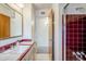 A bathroom featuring a large sink with a burgundy tile countertop, and a shower tub with tile at 1945 E Solano Dr, Phoenix, AZ 85016