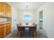 Well-lit dining room featuring modern chandelier and views into the kitchen at 1945 E Solano Dr, Phoenix, AZ 85016