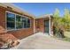 Inviting front entrance with brick accents, security door and desert landscaping at 1945 E Solano Dr, Phoenix, AZ 85016