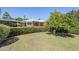 Well-manicured front yard with lush lawn, mature landscaping, and charming home exterior at 1945 E Solano Dr, Phoenix, AZ 85016