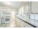 Well-maintained kitchen with white cabinets, tiled countertops and flooring at 1945 E Solano Dr, Phoenix, AZ 85016