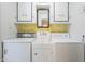 Bright laundry room featuring a utility sink with vintage GE appliances, and yellow floral wallpaper at 1945 E Solano Dr, Phoenix, AZ 85016
