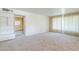 Bright living room features plush carpeting and built-in shelving at 1945 E Solano Dr, Phoenix, AZ 85016