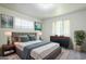 Calming main bedroom with gray headboard, soft rug, modern art, and leafy plant at 1945 E Solano Dr, Phoenix, AZ 85016