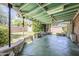 A covered patio features green roofing, concrete flooring, stone, and a view of the fenced backyard at 1945 E Solano Dr, Phoenix, AZ 85016