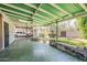 Relax on the covered patio with green roofing and concrete flooring, and enjoy the lovely backyard at 1945 E Solano Dr, Phoenix, AZ 85016