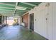 Covered patio with a green ceiling, green concrete, storage, and secure metal gate at 1945 E Solano Dr, Phoenix, AZ 85016