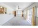 Bright, airy sun room with neutral carpet, white walls, and sliding door for lots of light at 1945 E Solano Dr, Phoenix, AZ 85016