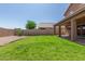 The backyard features lush grass, desert landscaping, gravel, and a covered patio, perfect for outdoor enjoyment at 19933 N Emmerson Dr, Maricopa, AZ 85138