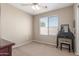 Bedroom includes neutral walls, carpet, and a dark vanity near the window at 19933 N Emmerson Dr, Maricopa, AZ 85138